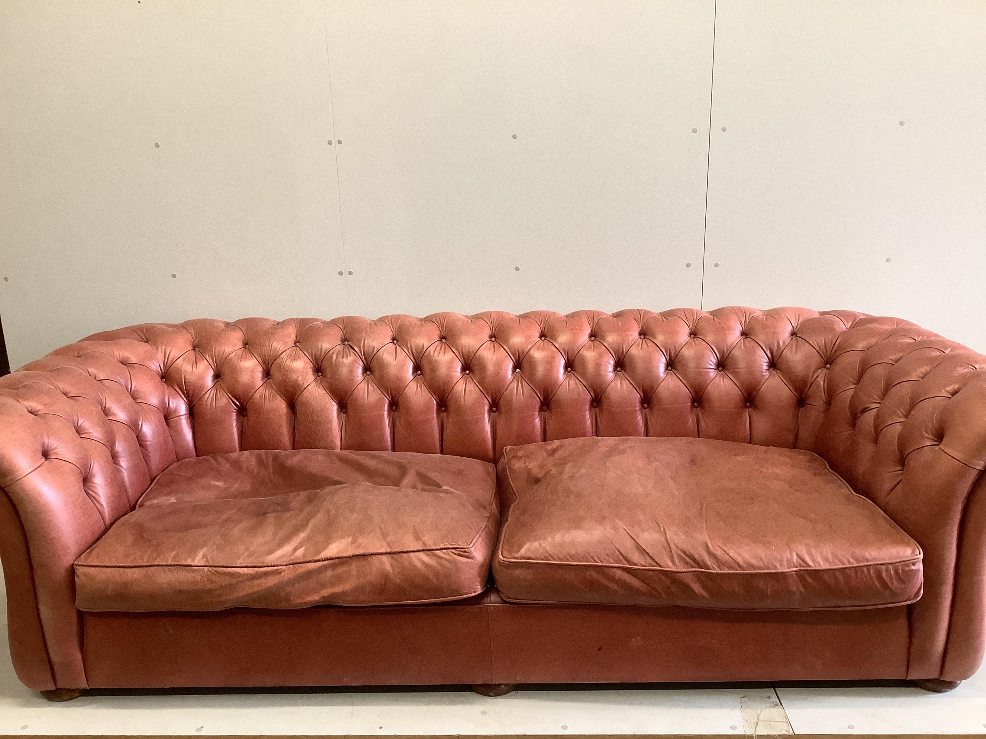 A large Victorian style buttoned back pale red leather Chesterfield settee, width 270cm, depth
