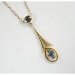 An Edwardian Art Nouveau 15ct and two stone aquamarine set drop pendant necklace, overall 43cm,