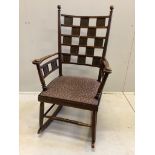 An Arts & Crafts rocking chair, the tablet back with Latin inscription, width 60cm, depth 52cm,
