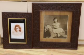 A large photographic print, Infant on rocking horse, housed in a carved frame ‘Russel, 1891’, and