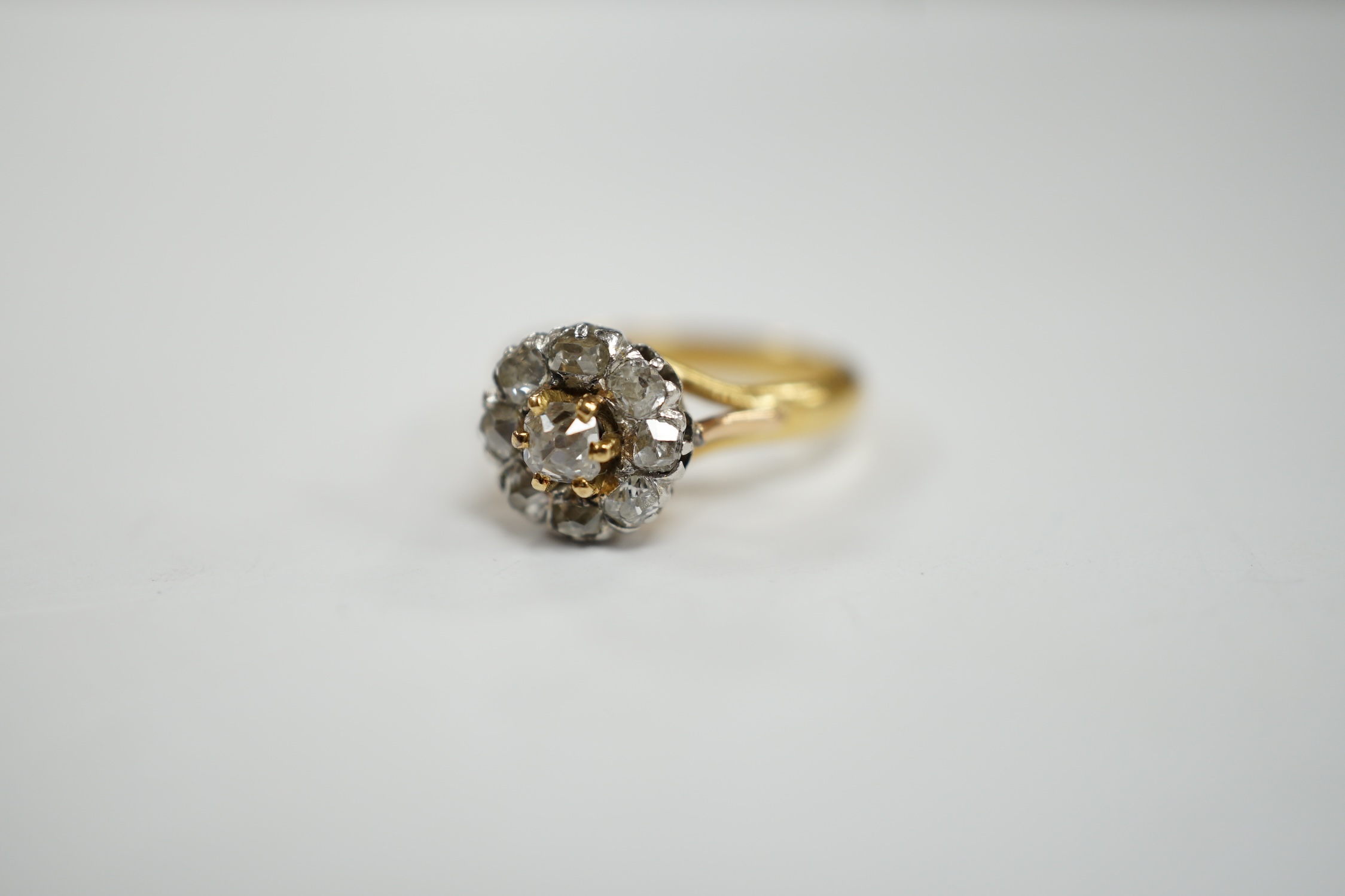 An early 20th century French 18k and nine stone diamond set flower head cluster ring, size G, - Image 3 of 5