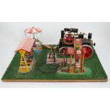 A Wilesco live steam fairground diorama, comprising a D430 pellet fired traction engine, powering