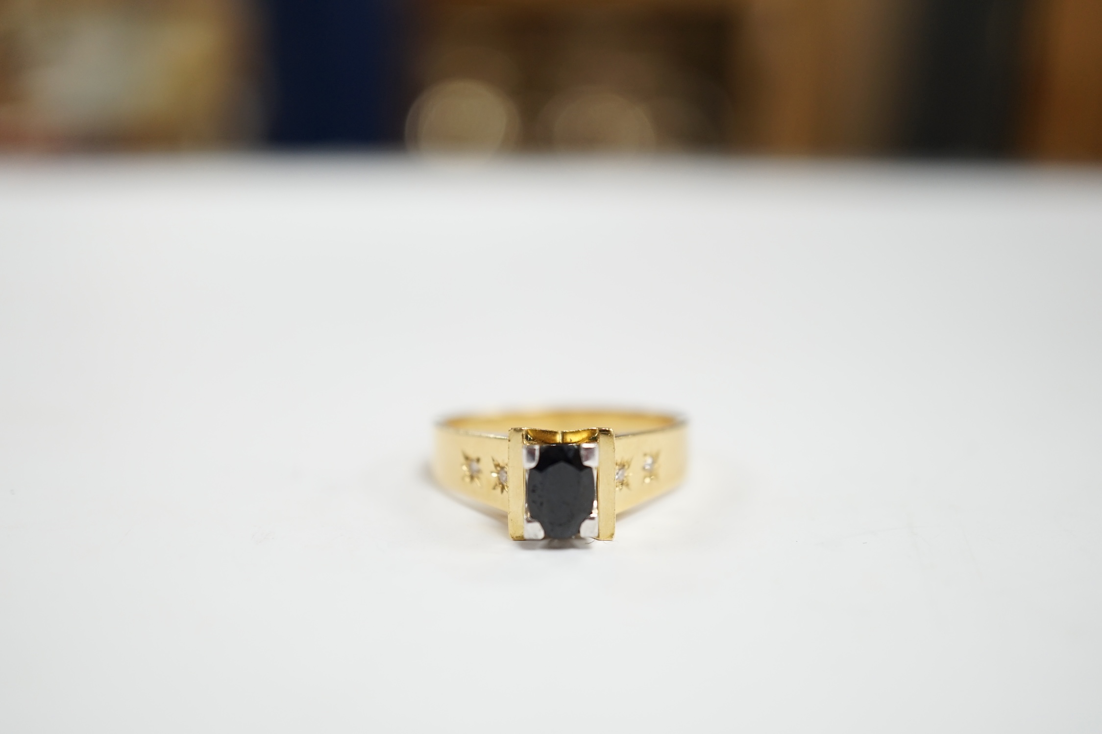 An 18ct and single stone oval cut sapphire set dress ring, with four stone gypsy set diamond chip - Image 2 of 4