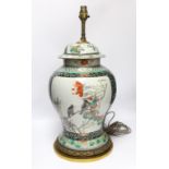 A Chinese famille verte porcelain baluster vase and cover, 19th century, decorated with birds