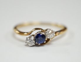An 18ct, single stone sapphire and two stone diamond set crossover ring, size O, gross weight 2.2