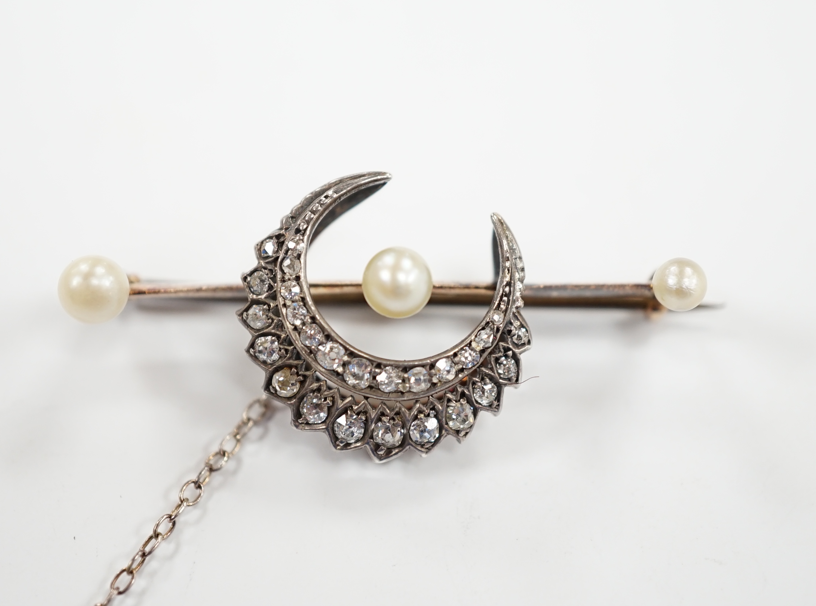 A Victorian yellow and white metal, diamond and pearl set crescent bar brooch, 44mm, gross weight