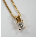 A modern 18ct gold and single stone fancy rectangular cut diamond set pendant, 9mm, on an 18ct