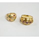 A textured yellow metal, emerald, ruby and diamond set domed ring, size K, together with a stylish