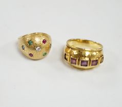 A textured yellow metal, emerald, ruby and diamond set domed ring, size K, together with a stylish