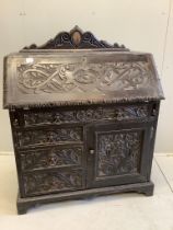 A late 19th century Flemish carved oak bureau, width 100cm, depth 49cm, height 133cm