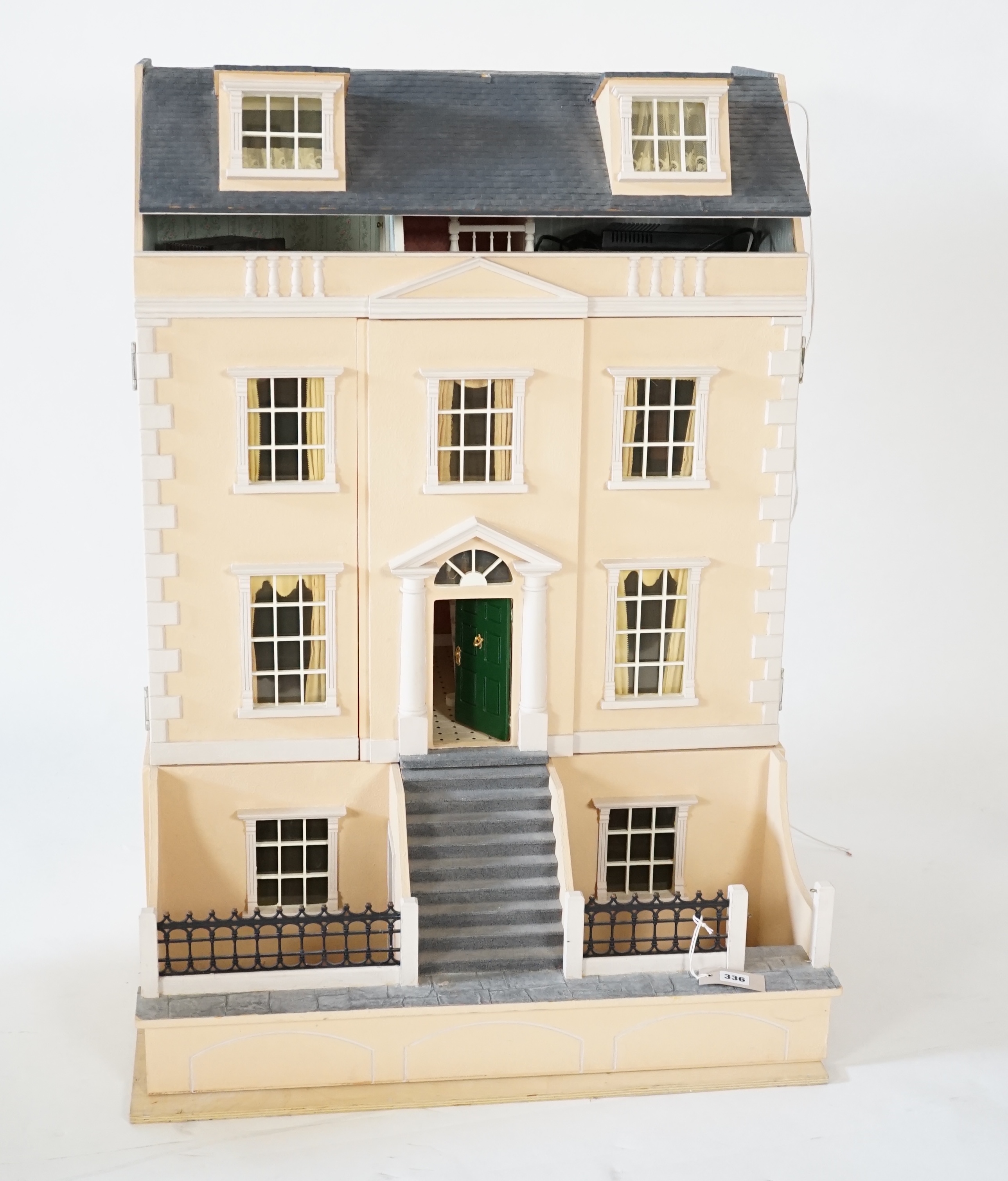 A large modern Georgian style dolls house and extensive contents, with eight fully decorated rooms