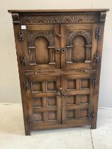 A Jacobean Revival oak cocktail cabinet, width 94cm, depth 49cm, height 139cm