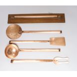 A set of five French copper utensils with hanging rack