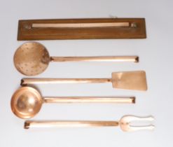 A set of five French copper utensils with hanging rack