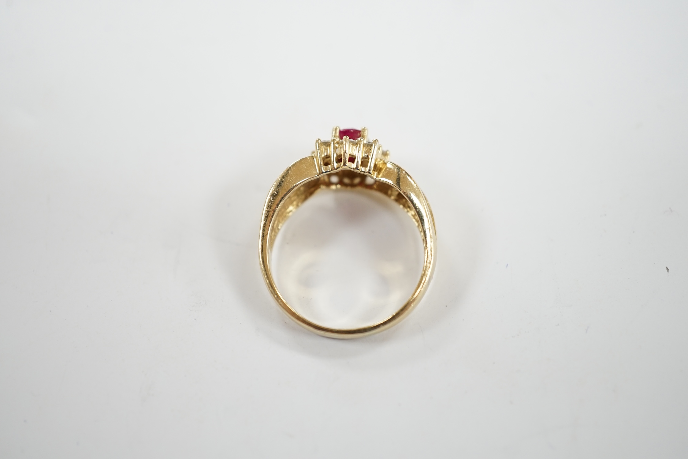 A modern 14k, ruby and diamond set oval cluster dress ring, with diamond chip set shoulders, size P, - Image 4 of 4