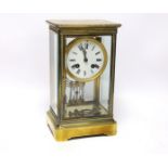 A late 19th century four glass brass clock with key and pendulum, 27cm