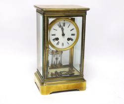 A late 19th century four glass brass clock with key and pendulum, 27cm