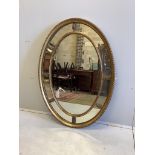 An Adam style oval giltwood wall mirror with marginal plates and acanthus decoration, width 113cm,
