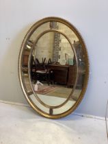 An Adam style oval giltwood wall mirror with marginal plates and acanthus decoration, width 113cm,