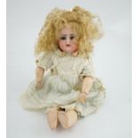 A Kammer & Reinhart / S & H bisque head doll, pierced ears, vintage clothes, one finger missing,