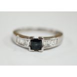 A modern 18ct white gold and single stone square cut sapphire set ring, with baguette cut diamond