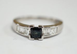 A modern 18ct white gold and single stone square cut sapphire set ring, with baguette cut diamond