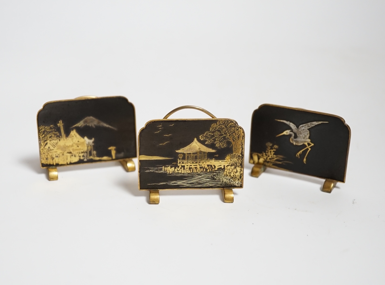 Three Japanese gold damascened iron menu holders by S. Komai, in original box, each 5cm wide