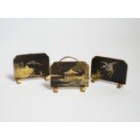 Three Japanese gold damascened iron menu holders by S. Komai, in original box, each 5cm wide