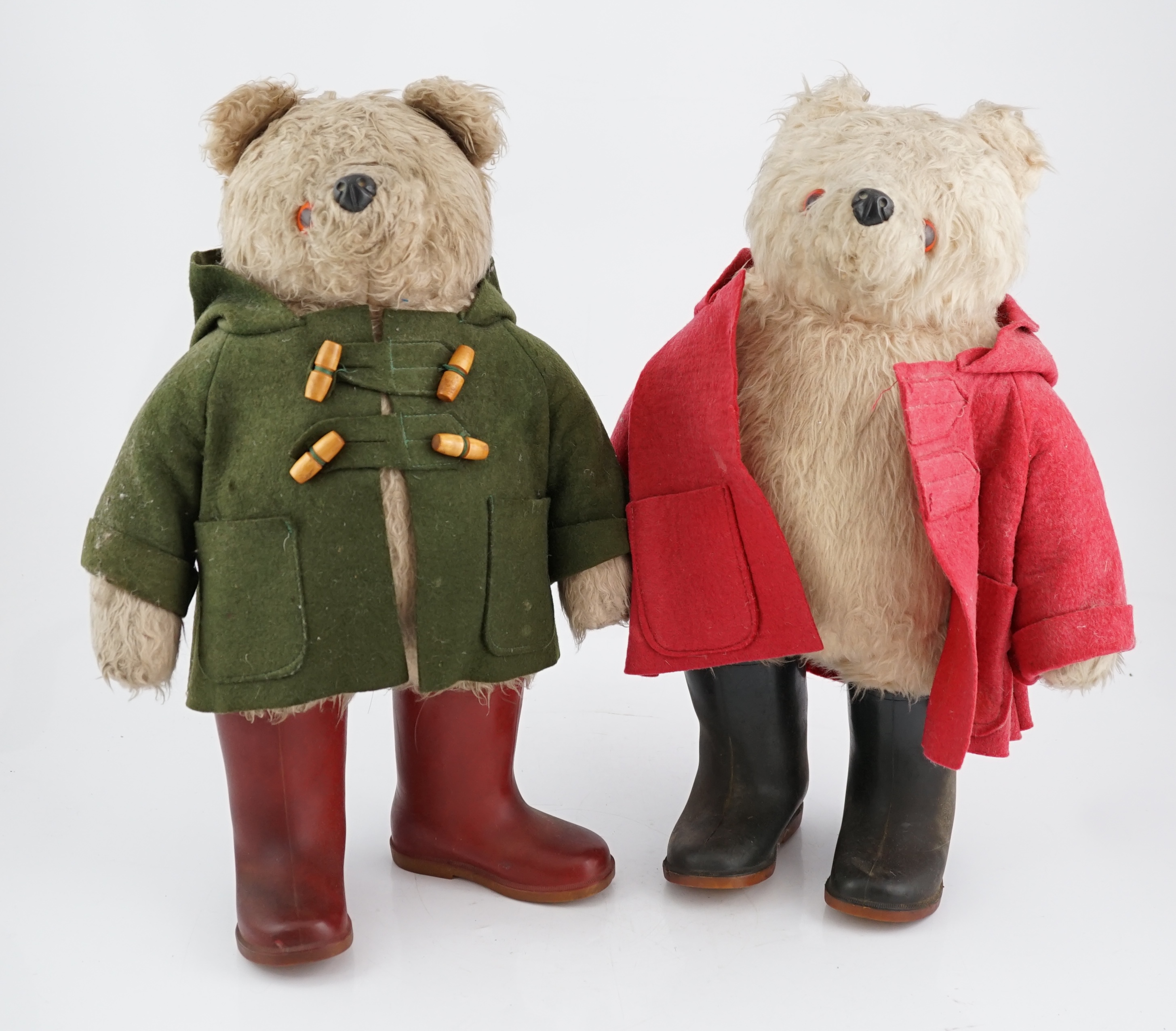 An early Paddington bear, green jacket, missing hat, and a similar Paddington with Dunlop boots, red
