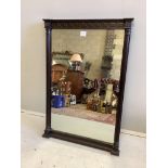 An Edwardian mahogany wall mirror with fluted pilasters and shallow carved frieze, width 64cm,