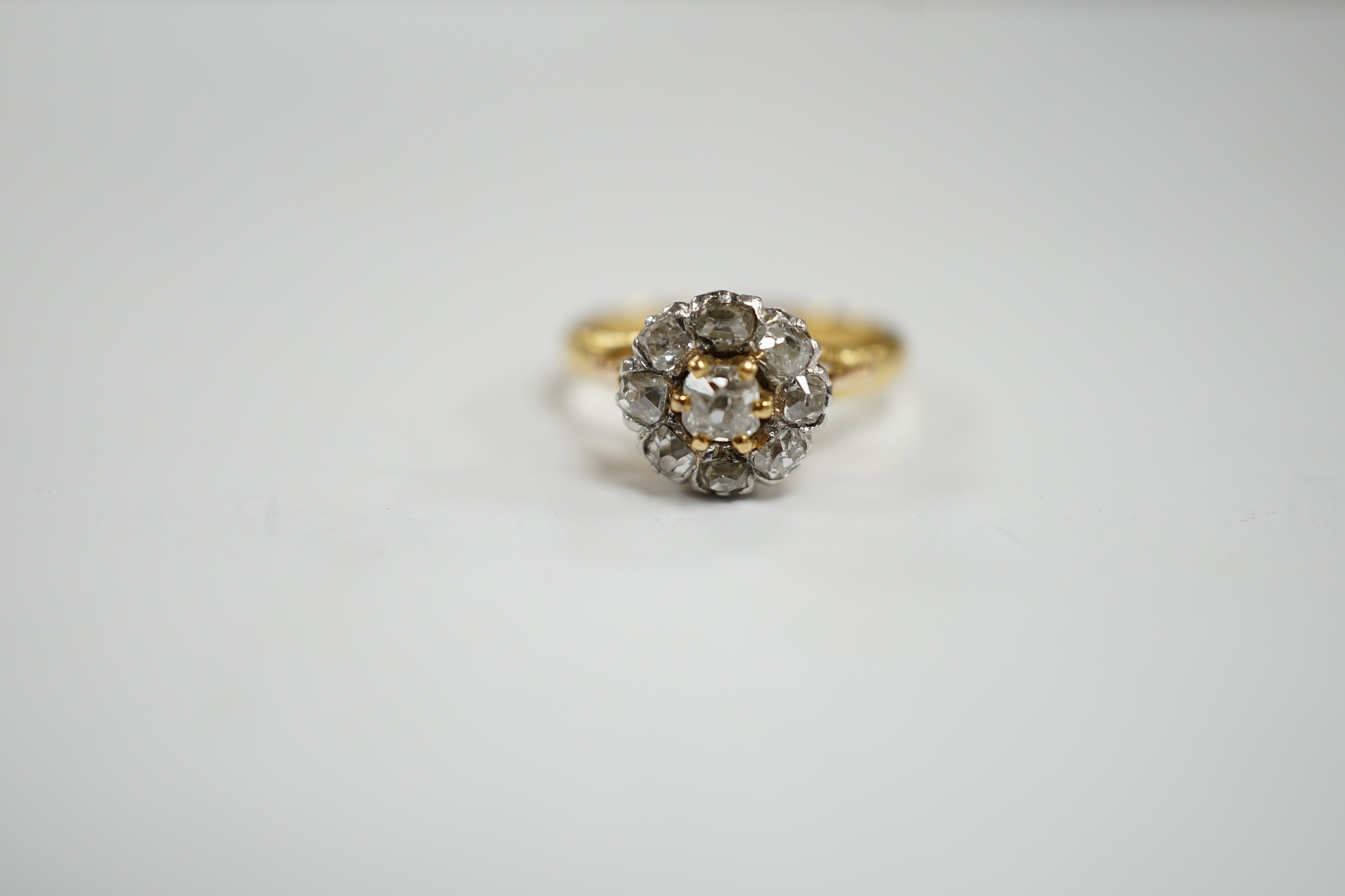 An early 20th century French 18k and nine stone diamond set flower head cluster ring, size G, - Image 2 of 5