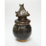 A Khmer brown glazed jar and cover, Cambodia, 12th century, 18cm