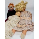 Three dolls; a German Bisque shoulder head doll with sleeping eyes with jointed kid leather body,
