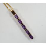 A modern yellow metal, amethyst and diamond chip set line pendant, 47mm, on an 18ct gold fine link