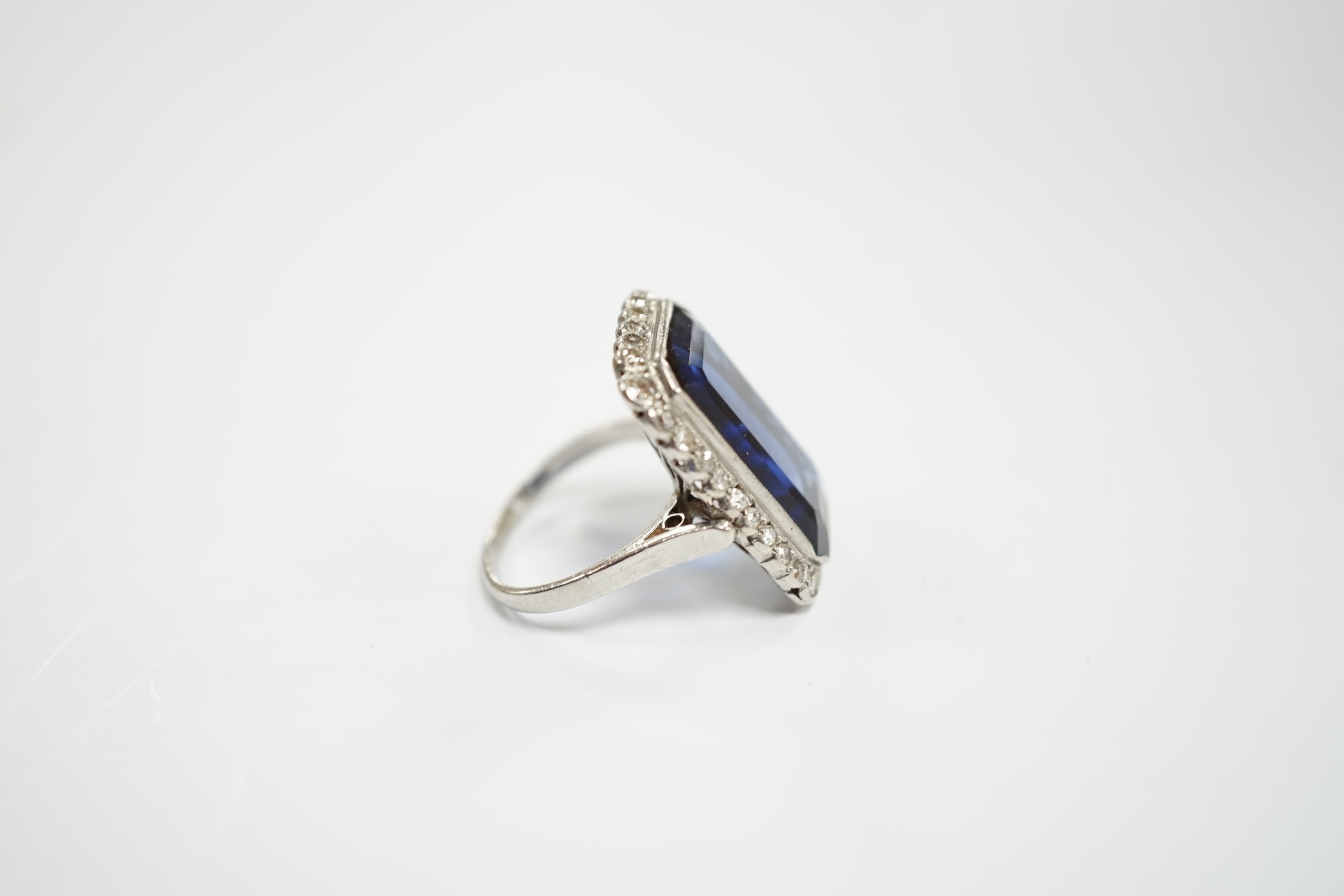 A 1920's white metal and single stone emerald cut synthetic sapphire set dress ring, with millegrain - Image 3 of 5