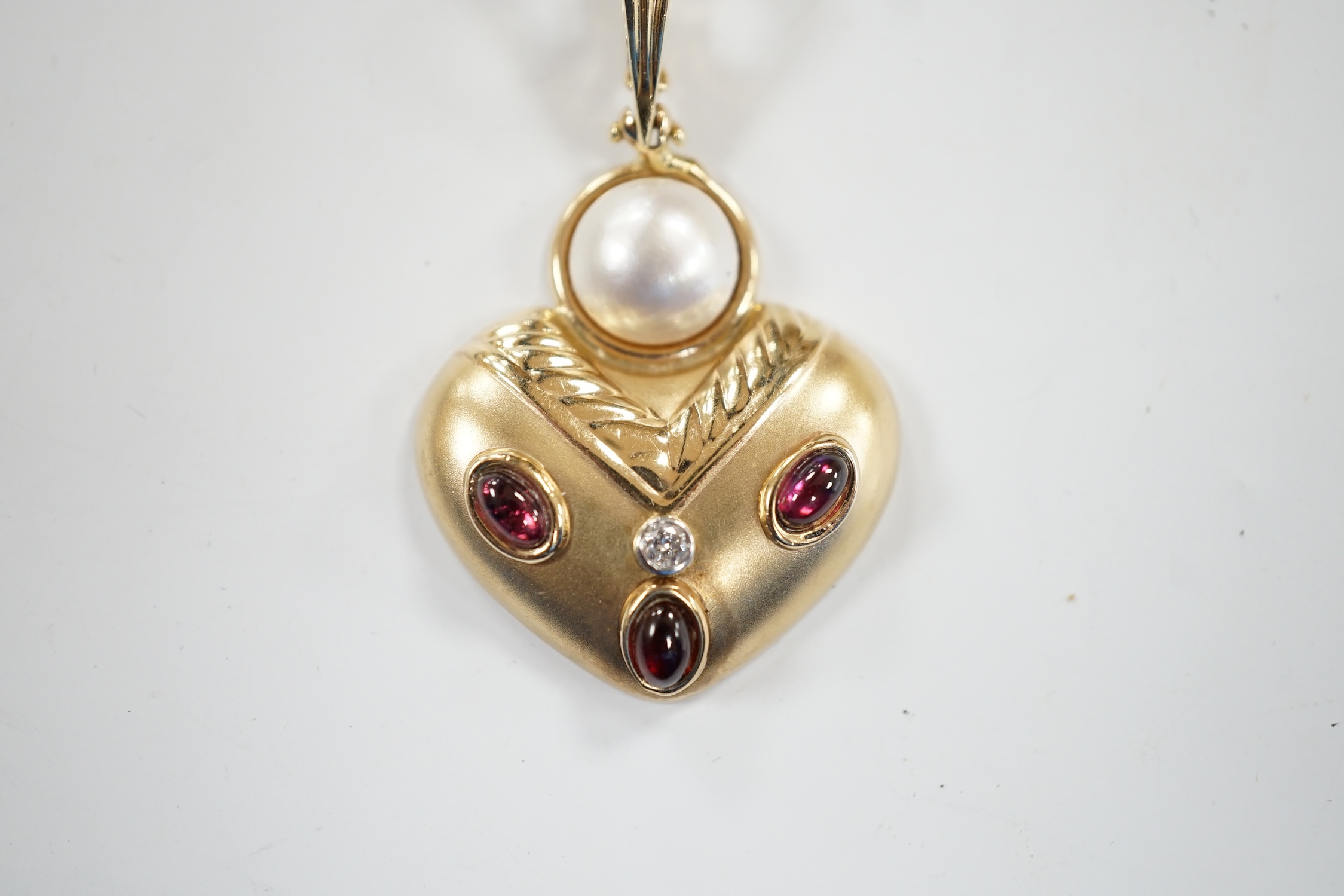 A modern unmarked yellow metal, mabe pearl, cabochon garnet and diamond set pendant, width 28mm, - Image 2 of 3