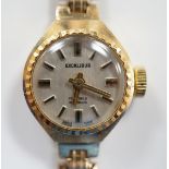A lady's 9ct gold Excalibur manual wrist watch, on a 9ct gold bracelet, overall 17.5cm, gross weight