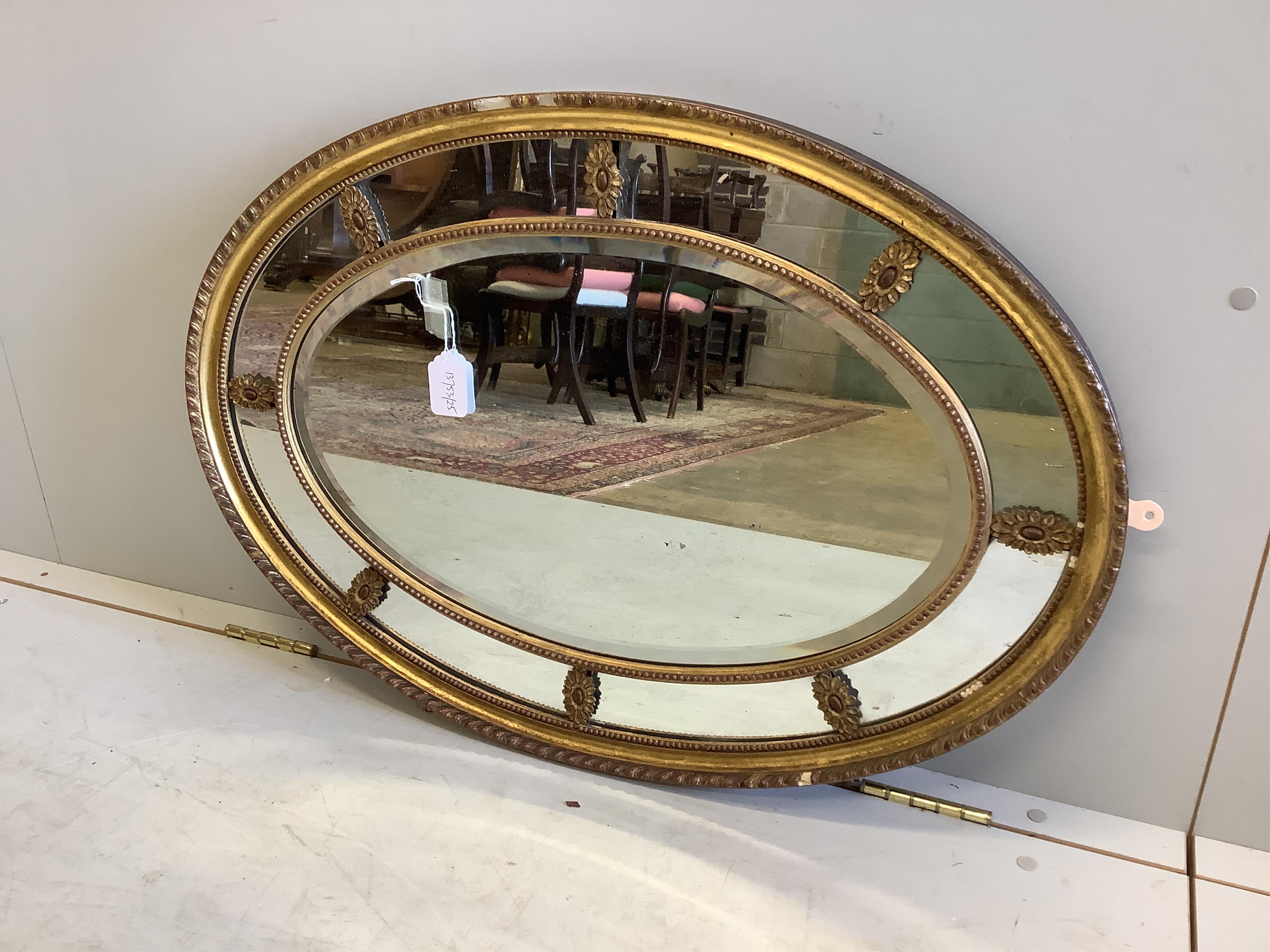 A Victorian Adam style oval giltwood and composition wall mirror with marginal plate, width 81cm,
