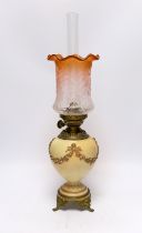 A Royal Worcester blush ivory oil lamp with fluted glass shade, 46cm high