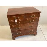 A Georgian style mahogany flush top chest fitted two short and three long drawers, on bracket