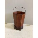 A 19th century octagonal inlaid mahogany waste paper bin, raised on bracket supports, width 26cm,