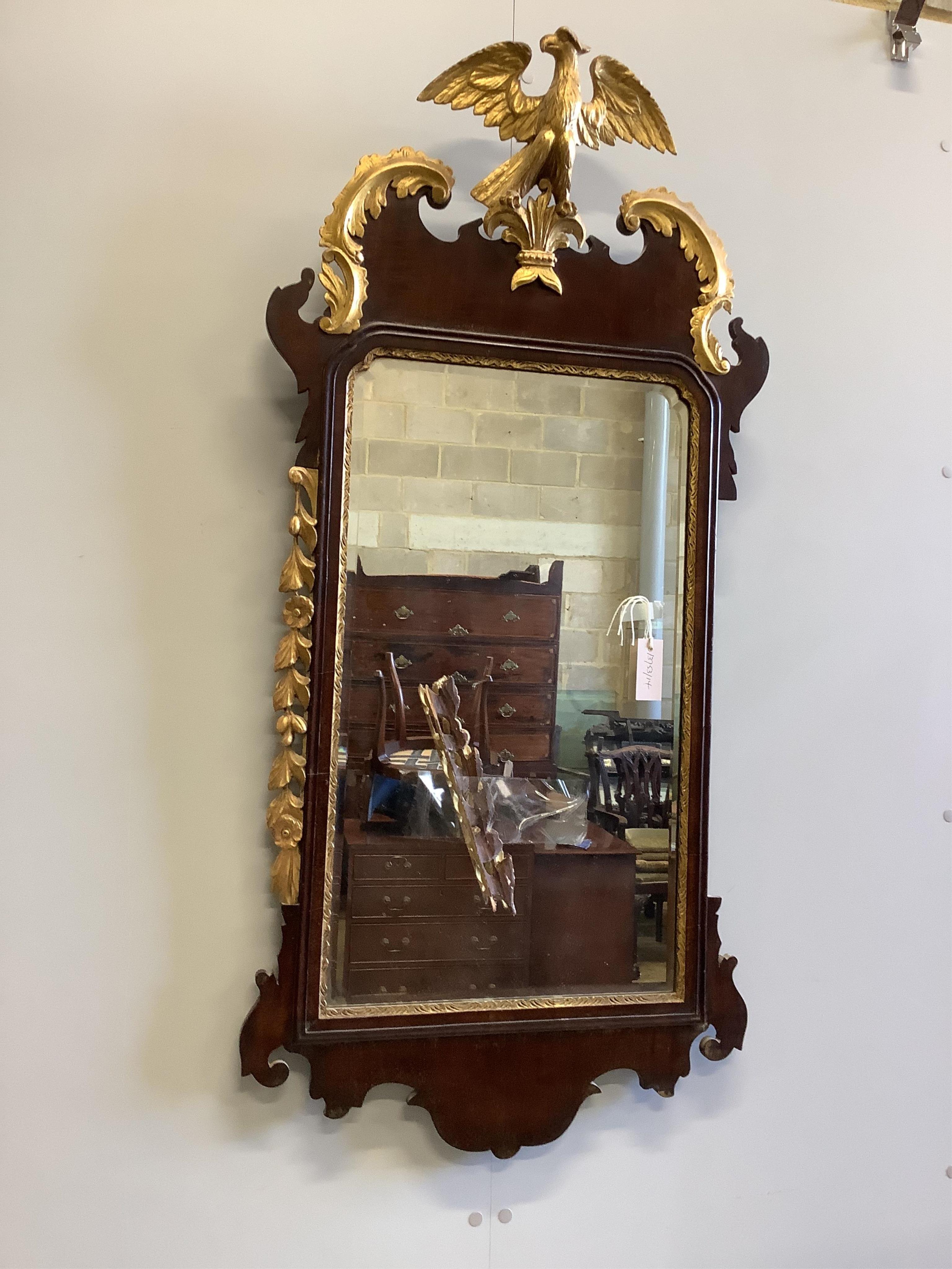 An early 19th century Chippendale design mahogany and parcel gilt fret carved pier glass, having
