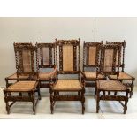 A set of seven Jacobean Revival caned oak dining chairs, one with arms