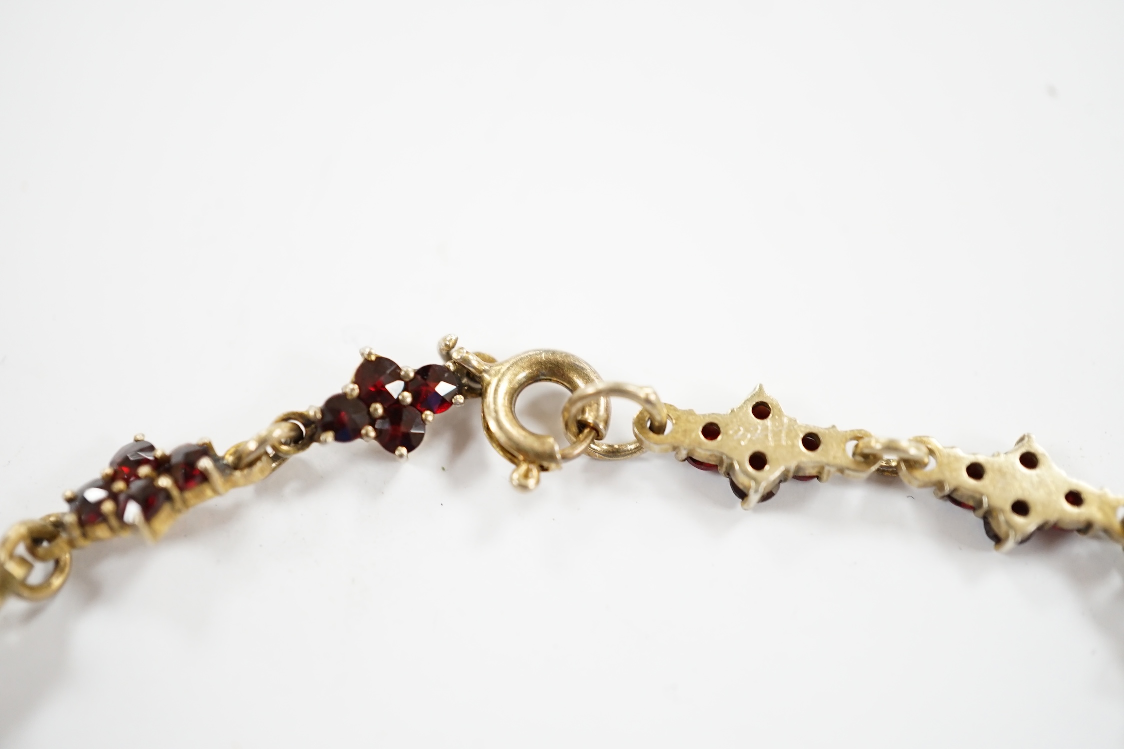An early 20th century gilt sterling and garnet cluster set drop necklace, 45cm. - Image 4 of 5