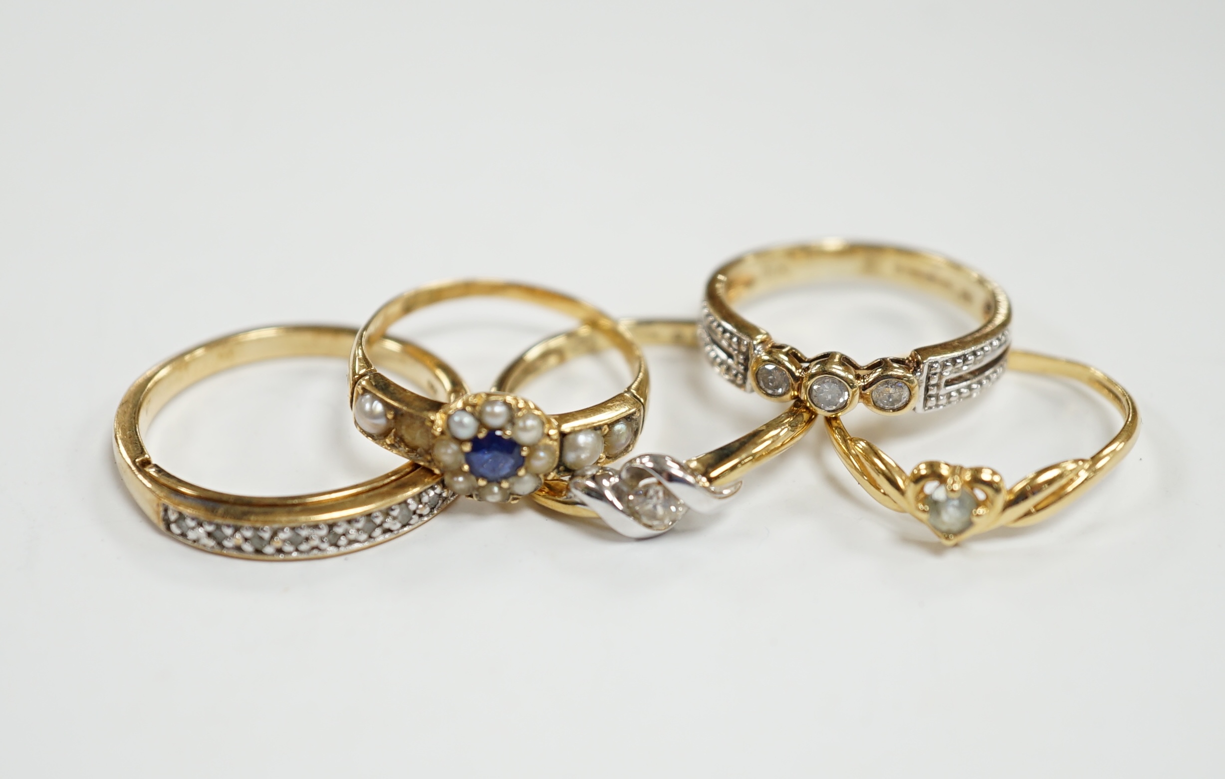Three assorted modern 9ct gold and diamond set rings, gross 6.5 grams and two other yellow metal and
