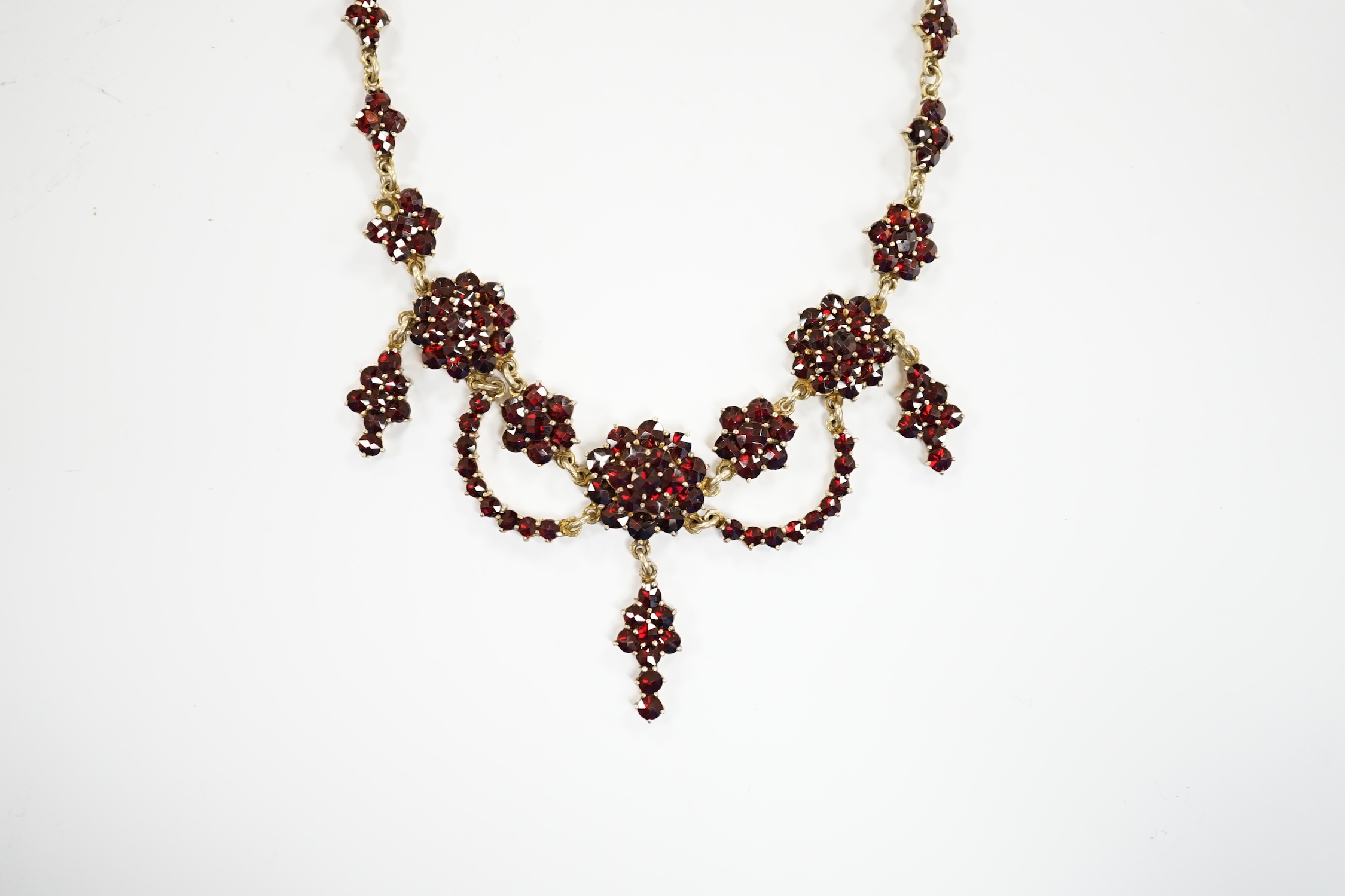 An early 20th century gilt sterling and garnet cluster set drop necklace, 45cm. - Image 3 of 5