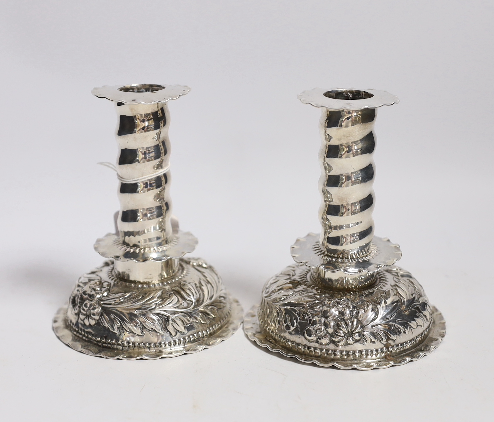 A matched pair of Carolean style silver dwarf candlesticks, London, 1880 & 1885, makers mark on