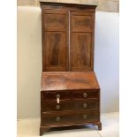 A late Georgian mahogany bureau bookcase crossbanded and inlaid upper section, fitted a pair of