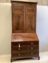 A late Georgian mahogany bureau bookcase crossbanded and inlaid upper section, fitted a pair of