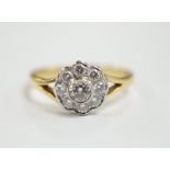 A modern 18ct gold and nine stone diamond set flower head cluster ring, size M, gross weight 3